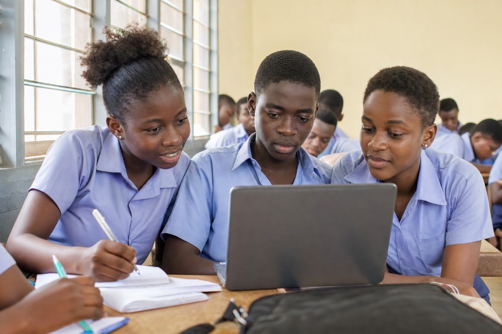 Students studying together with a laptop in class